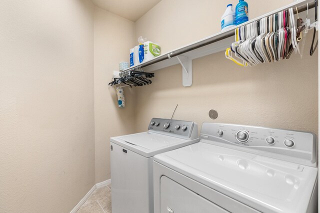 washroom featuring washing machine and clothes dryer and light tile patterned floors