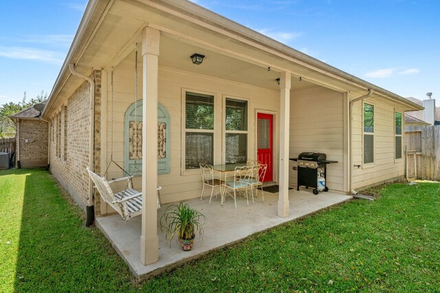 back of house featuring a patio, central air condition unit, and a lawn