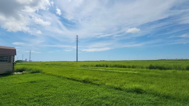 view of yard with a rural view