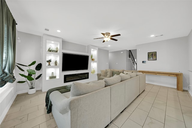 tiled living room featuring ceiling fan