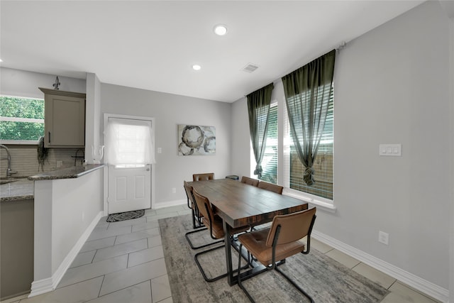 dining area with sink and light tile patterned floors