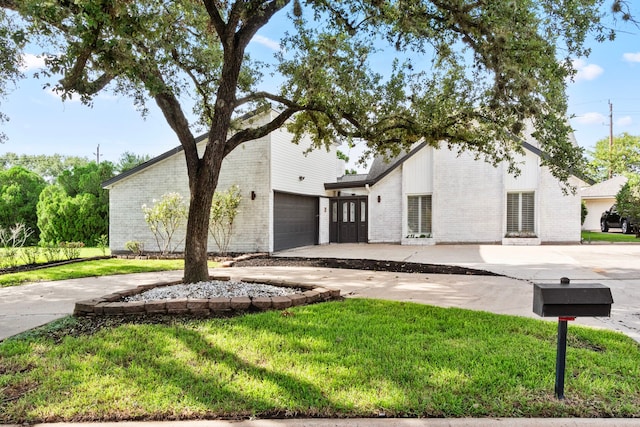 view of front of house with a front lawn and a garage