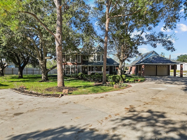 view of front of house featuring a garage and a front lawn