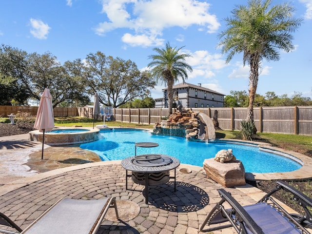 view of pool with an in ground hot tub, pool water feature, and a patio