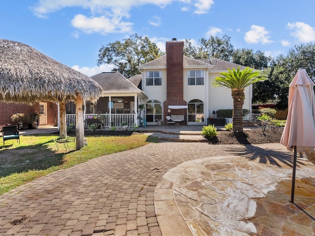 rear view of house with a patio area and a yard