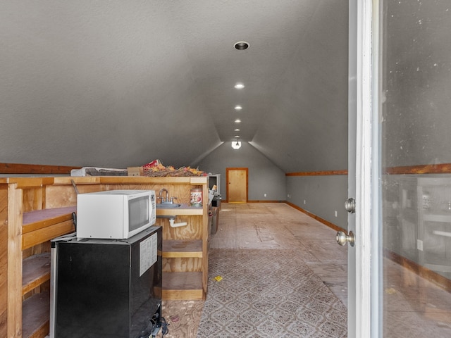 bonus room featuring sink and vaulted ceiling