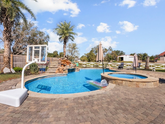 view of swimming pool featuring an in ground hot tub