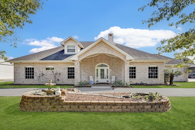 view of front of property with a front lawn and french doors