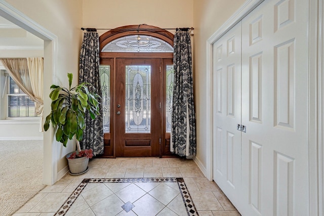 foyer featuring light colored carpet