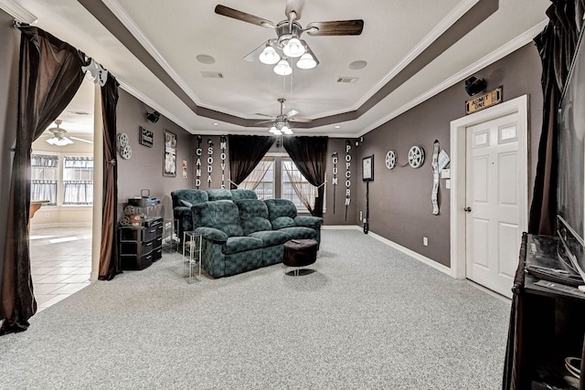 home theater featuring plenty of natural light, crown molding, and light carpet