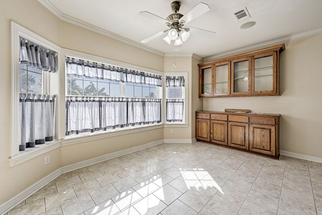 tiled spare room with ornamental molding and ceiling fan