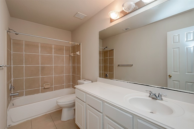 full bathroom featuring vanity, tile patterned flooring, tiled shower / bath, and toilet