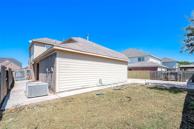 view of side of property featuring a yard and central AC unit