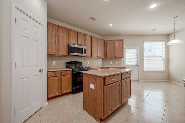 kitchen featuring a center island, tasteful backsplash, black range with gas cooktop, decorative light fixtures, and light tile patterned floors