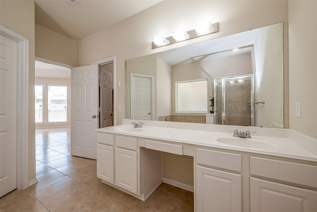 bathroom with tile patterned floors, vanity, and walk in shower