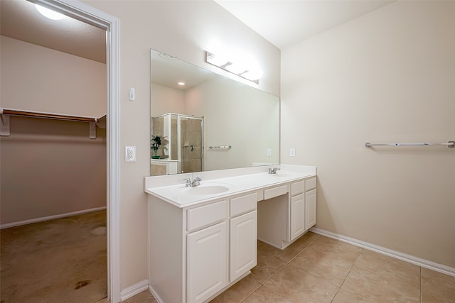 bathroom featuring tile patterned floors, vanity, and walk in shower