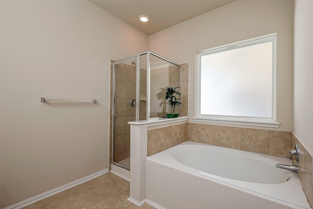 bathroom with tile patterned flooring and shower with separate bathtub