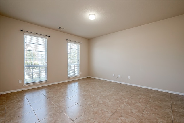 spare room featuring light tile patterned floors