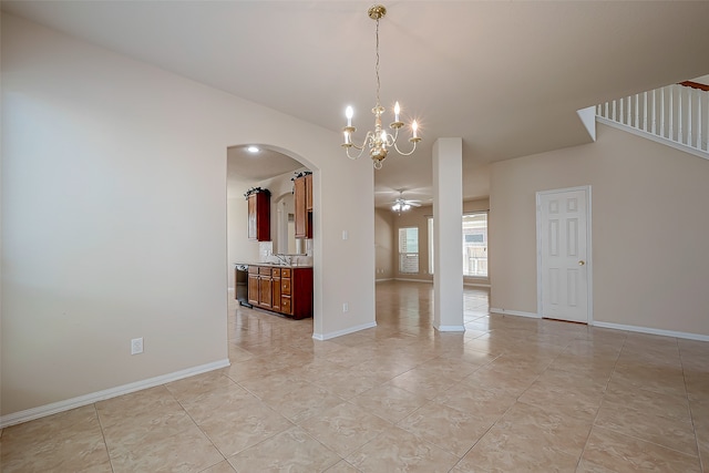 unfurnished dining area with light tile patterned flooring, ceiling fan with notable chandelier, and sink