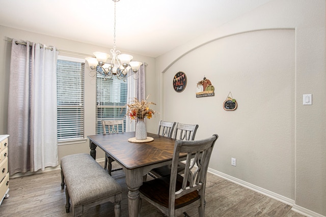 dining room featuring light hardwood / wood-style flooring and a notable chandelier