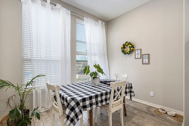 dining space with hardwood / wood-style flooring