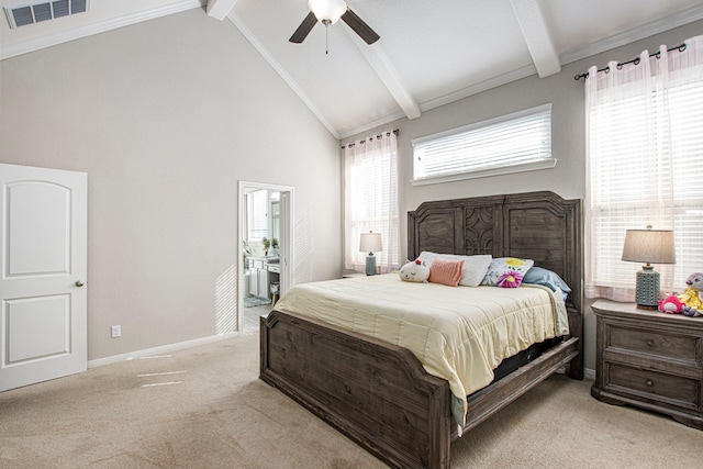 carpeted bedroom featuring ensuite bath, multiple windows, ceiling fan, and vaulted ceiling with beams