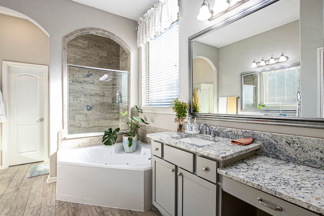 bathroom featuring vanity, hardwood / wood-style flooring, and separate shower and tub