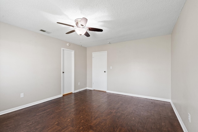 unfurnished room with ceiling fan, dark hardwood / wood-style floors, and a textured ceiling