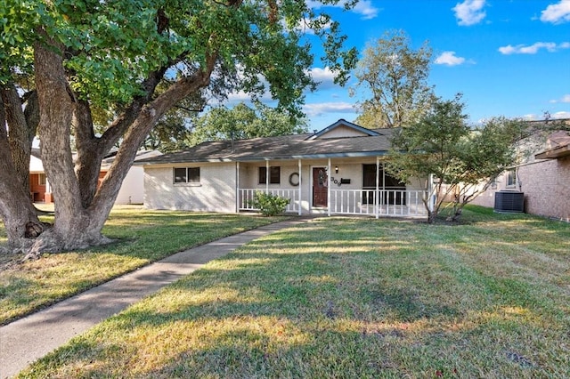 single story home with central air condition unit, covered porch, and a front yard