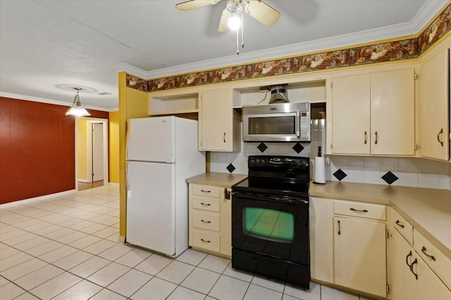 kitchen featuring cream cabinetry, black range with electric cooktop, white fridge, and crown molding