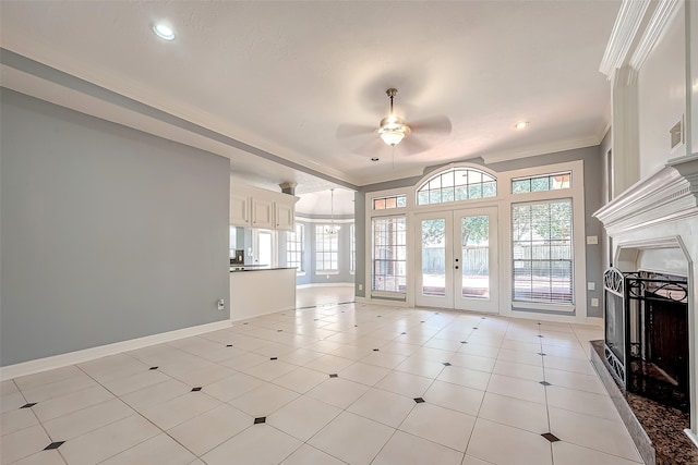 unfurnished living room with ceiling fan with notable chandelier, light tile patterned floors, french doors, and ornamental molding