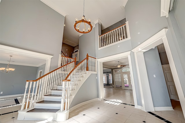 stairway with a towering ceiling, tile patterned floors, an inviting chandelier, and ornamental molding