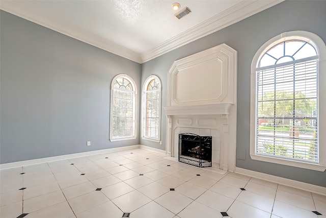 unfurnished living room with a textured ceiling, light tile patterned floors, a healthy amount of sunlight, and crown molding