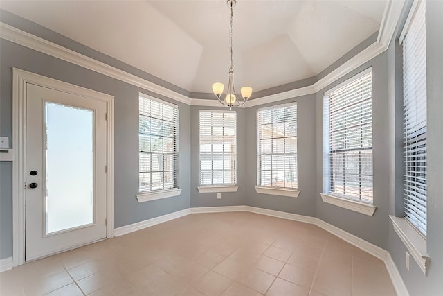 unfurnished dining area featuring ornamental molding, a wealth of natural light, and an inviting chandelier