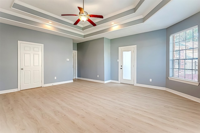 unfurnished room with crown molding, light hardwood / wood-style floors, and a raised ceiling