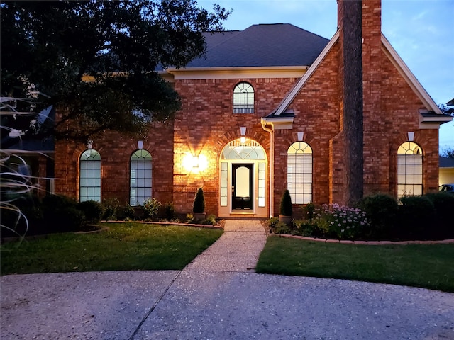 front facade with a front lawn