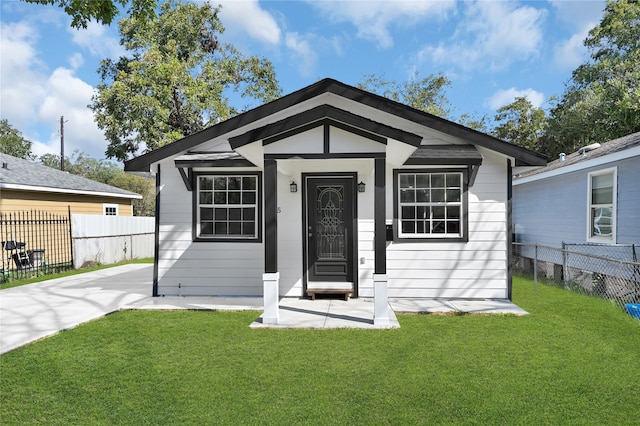 bungalow-style home featuring a front yard