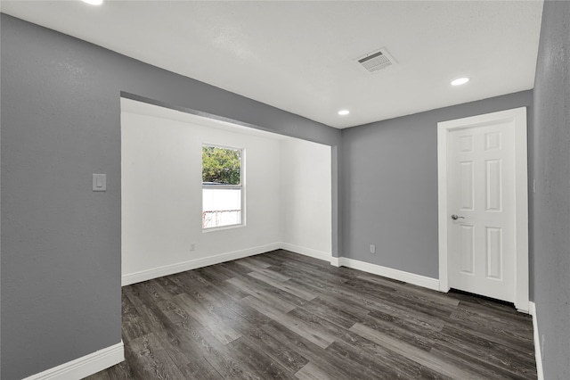 spare room featuring dark wood-type flooring