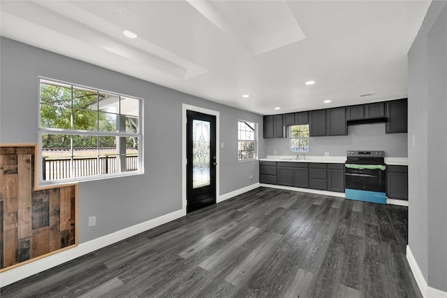 kitchen with stainless steel electric range oven, sink, a healthy amount of sunlight, and dark hardwood / wood-style floors