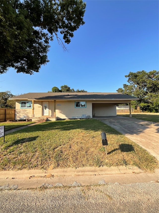 ranch-style house featuring a carport and a front yard