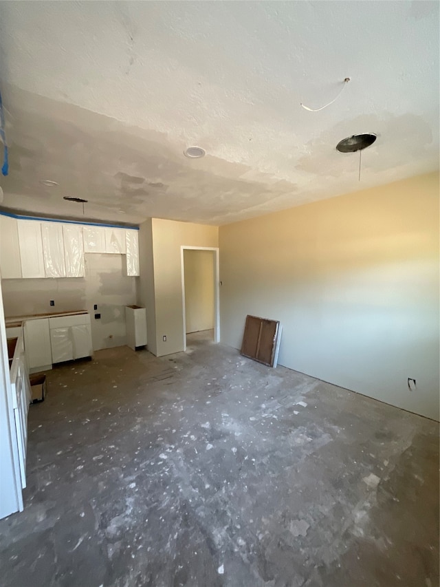 unfurnished room with a textured ceiling