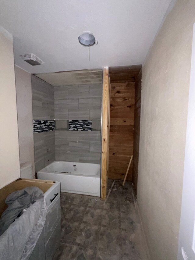 bathroom with toilet and a washtub