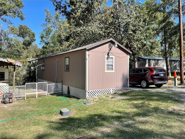 view of side of home with a yard