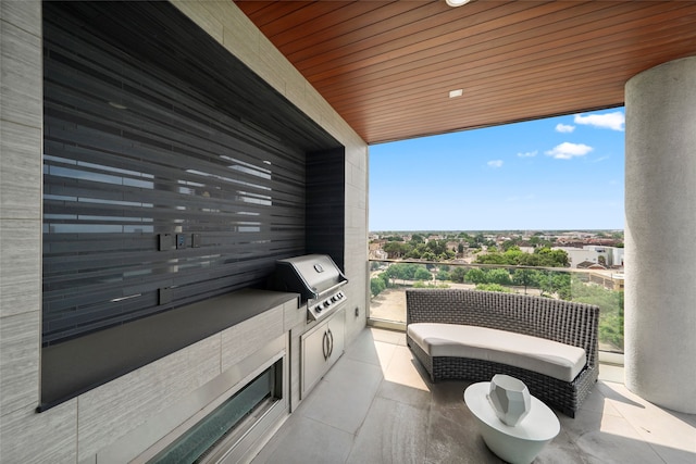 view of patio / terrace featuring an outdoor kitchen, a balcony, and a grill