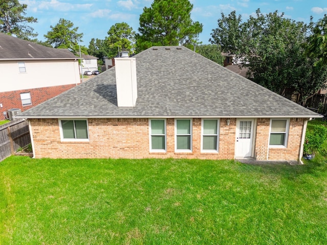 rear view of property featuring a yard