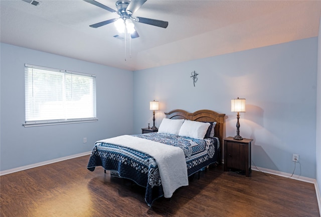 bedroom with ceiling fan and dark hardwood / wood-style floors