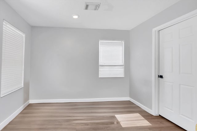 spare room with hardwood / wood-style floors