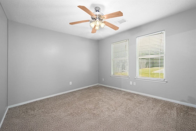 carpeted spare room with ceiling fan