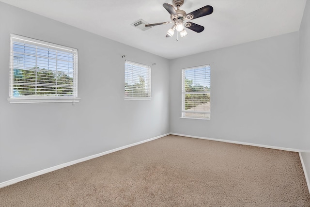 spare room featuring ceiling fan and carpet flooring