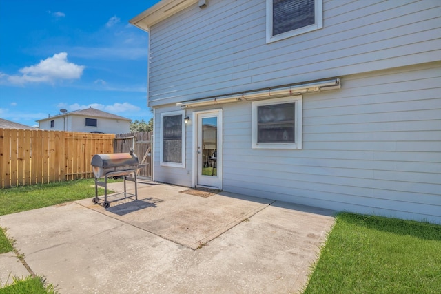 rear view of property featuring a yard and a patio area